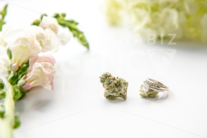 Diamond Wedding and Engagement Ring on Marijuana Bud with Pink Flowers Close Up – Cannabis Wedding - The Cannabiz Agency
