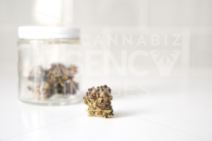 Glass Jar of Flowers on White Counter – Close Up - Cannabis Royalty Free Stock Images