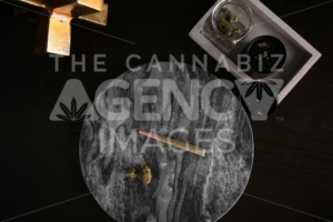Marijuana Joint, Buds and Grinder on Dark Marble Luxury Cannabis - The Cannabiz Agency