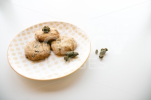Yellow Patterned Plate with Chocolate Chip Cookies and Marijuana Buds - The Cannabiz Agency