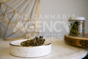 Flower Buds on Tray Flower in Glass Jar in Background on White Marble - Cannabis Royalty Free Stock Images