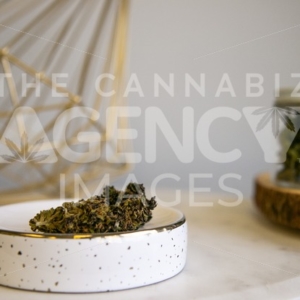 Flower Buds on Tray Flower in Glass Jar in Background on White Marble - Cannabis Royalty Free Stock Images