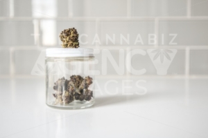 Glass Jar of Flowers on White Counter - Cannabis Royalty Free Stock Images