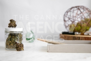 Pen on Wooden Tray, Flower Buds, Glass and Roll on White Marble - Cannabis Royalty Free Stock Images